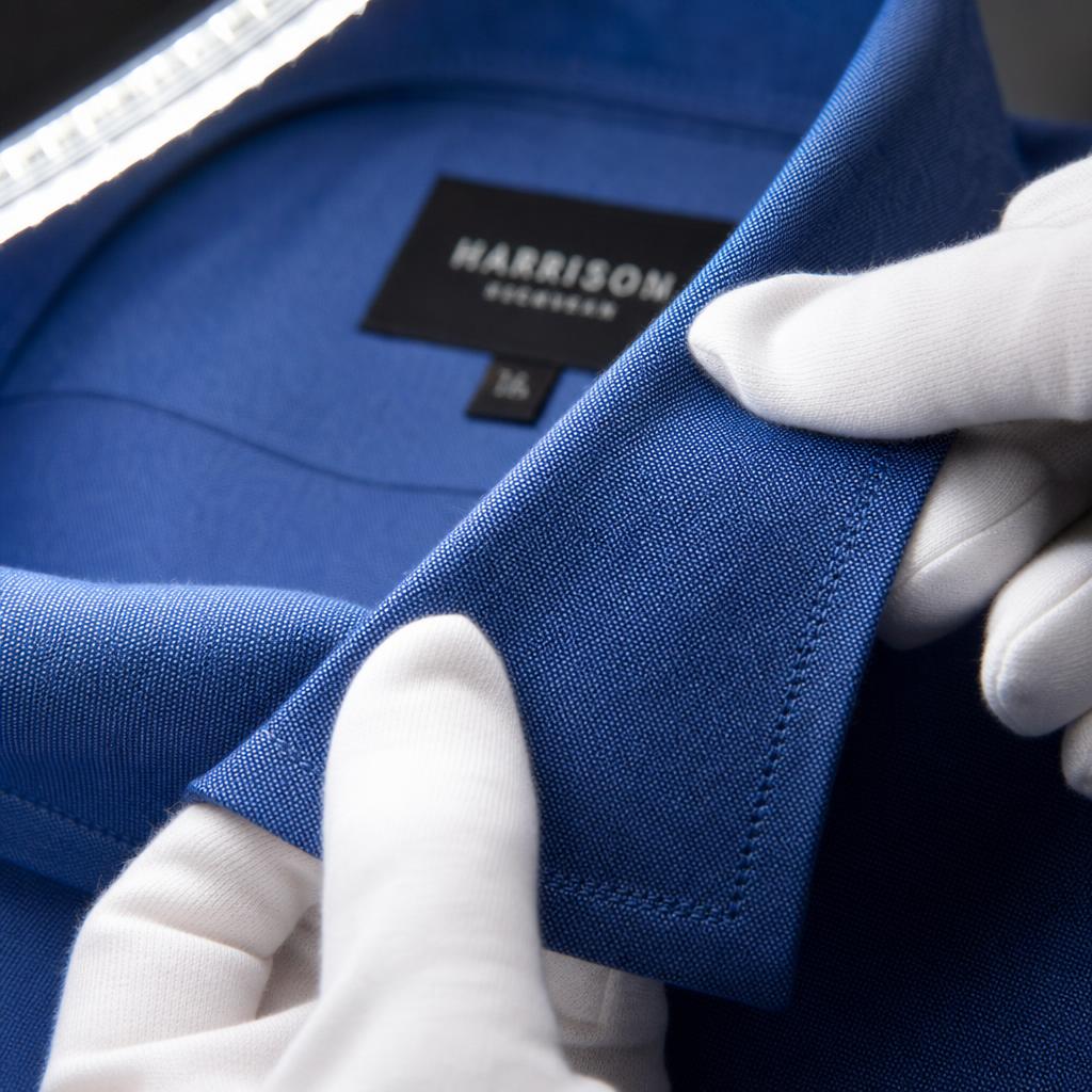 Inspection qualité d'une couture sur un vêtement bleu